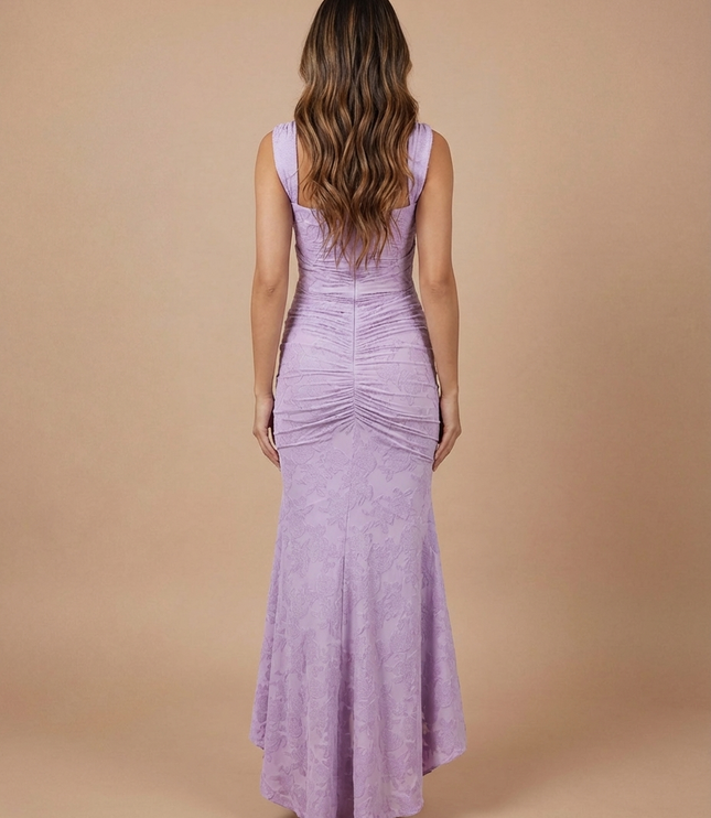 Back view of lavender lace midi dress with wide straps, fitted bodice, and ruched skirt