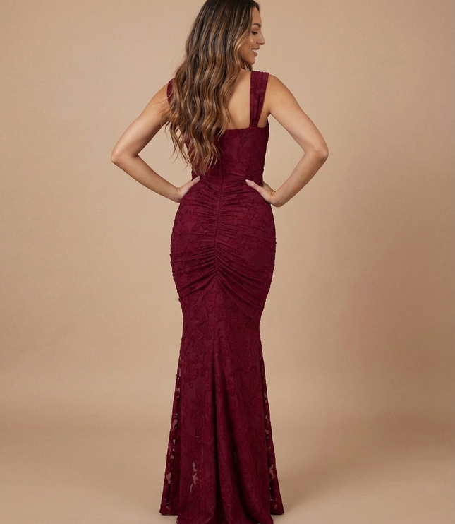Back view of burgundy lace midi dress with wide straps, ruched center seam, and flared hem