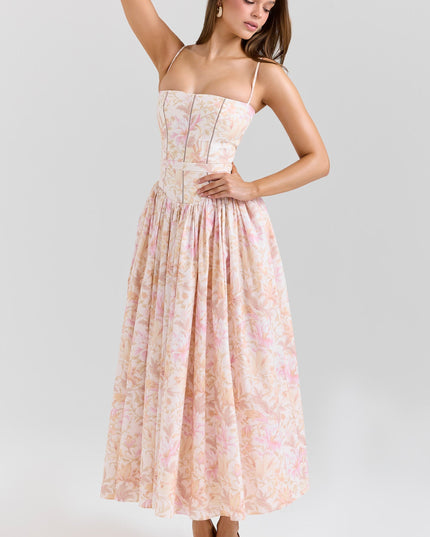 Side pose of blush floral corset midi dress highlighting fitted bodice and gathered skirt