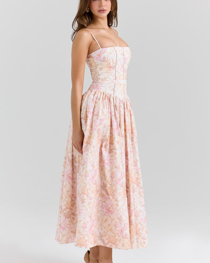 Three-quarter view of blush floral corset midi dress showing waist seam and flowy skirt