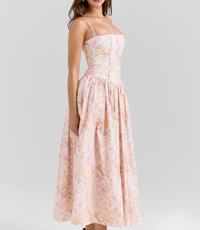 Three-quarter view of blush floral corset midi dress showing waist seam and flowy skirt