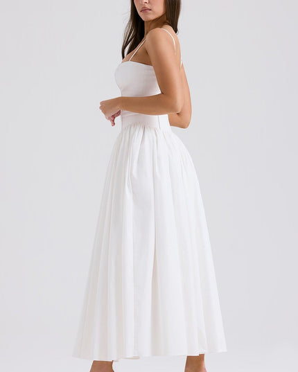 Side view of white corset midi dress with fitted bodice and voluminous gathered skirt