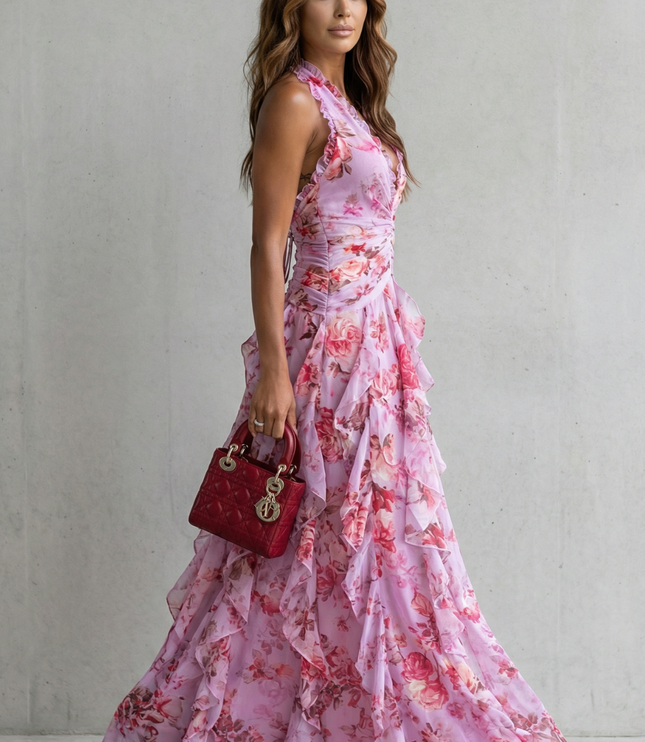 Side view of lilac floral halter maxi dress with fitted waist and cascading ruffle layers on skirt