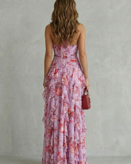 Back view of lilac floral halter maxi dress showing open back tie detail and flowing ruffle skirt