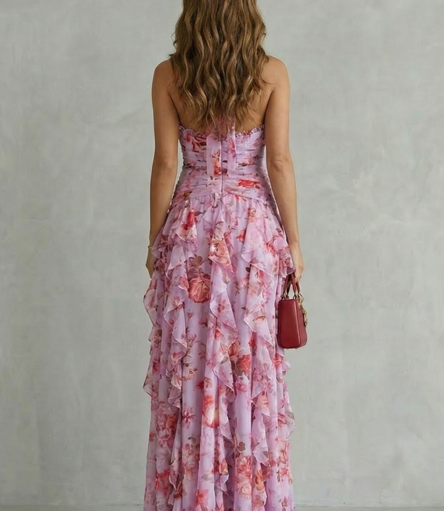 Back view of lilac floral halter maxi dress showing open back tie detail and flowing ruffle skirt