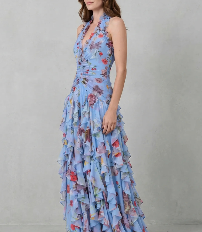 Side view of light blue floral halter maxi dress with fitted bodice and cascading ruffle skirt layers