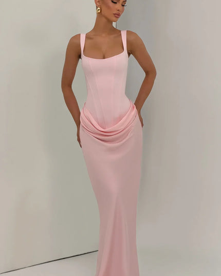Blush pink corset maxi dress front view with draped skirt and straps