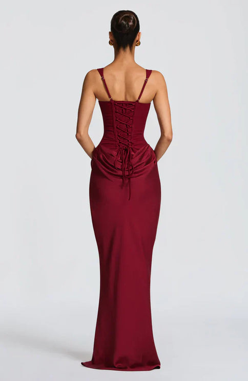 Back view of burgundy corset maxi dress with lace-up detail and ruched back waist