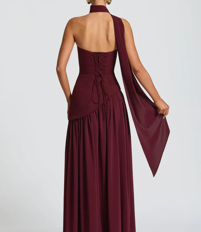 Back view of burgundy halter maxi dress with lace-up corset back and flowing skirt
