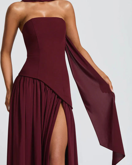 Burgundy halter maxi dress with strapless bodice, side slit, and draped scarf detail
