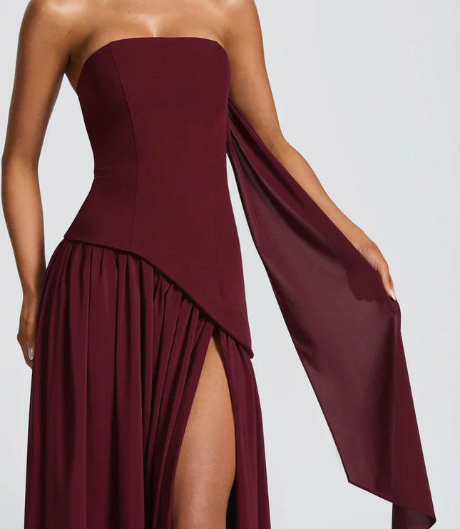 Burgundy halter maxi dress with strapless bodice, side slit, and draped scarf detail
