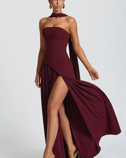 Burgundy halter maxi dress with high slit, draped bodice, and sweeping skirt movement