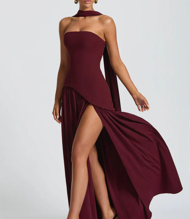 Burgundy halter maxi dress with high slit, draped bodice, and sweeping skirt movement