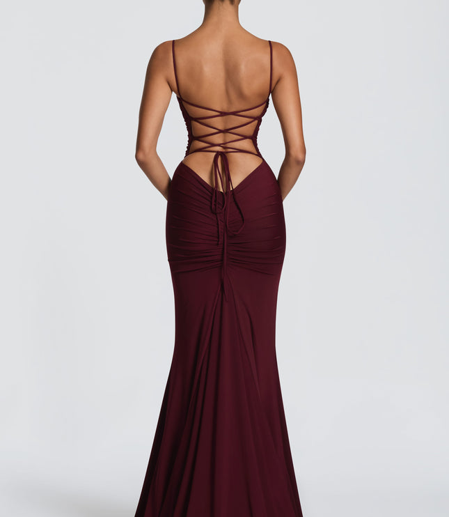 Back view of burgundy ruched maxi dress with lace-up open back and gathered center seam detail