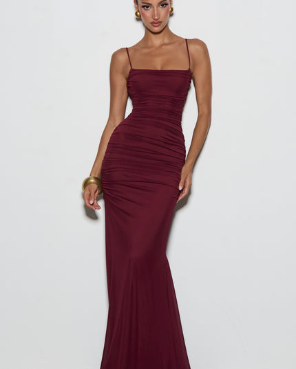 Burgundy lace-up back maxi dress angled rear view with crisscross straps and ruched skirt detail