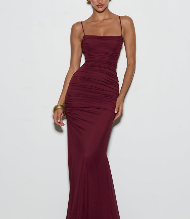 Burgundy lace-up back maxi dress angled rear view with crisscross straps and ruched skirt detail