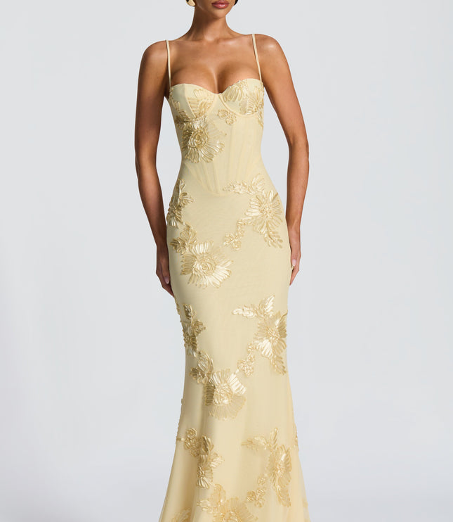 Butter yellow lace maxi dress with thin straps, corset seams and floral appliqué, front view