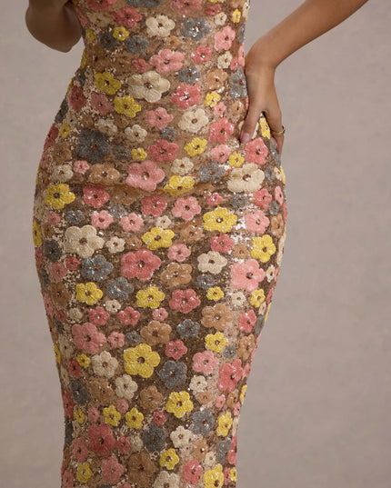 Detail closeup of champagne floral sequin fabric with pink, yellow, and gray flower pattern