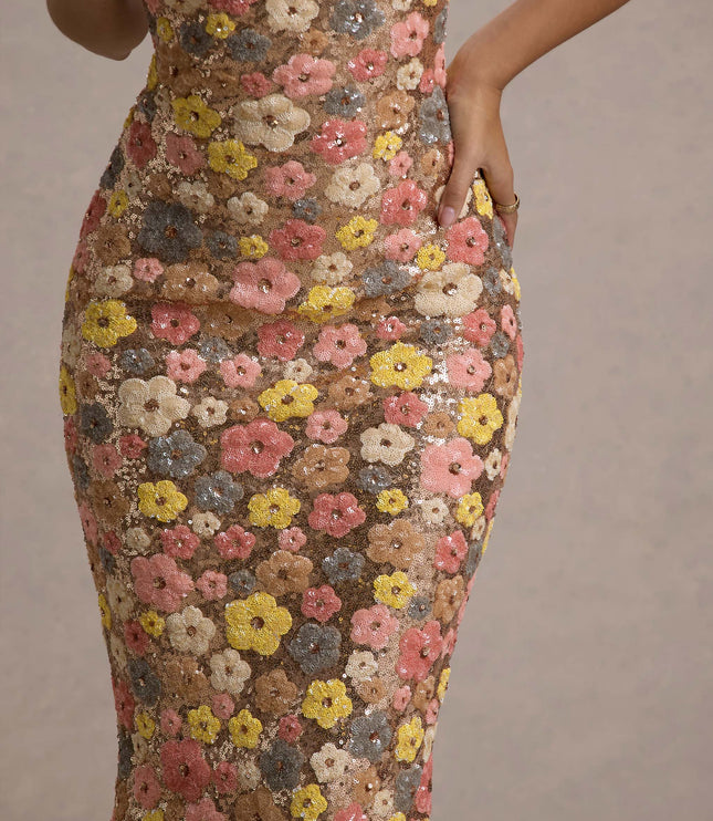 Detail closeup of champagne floral sequin fabric with pink, yellow, and gray flower pattern