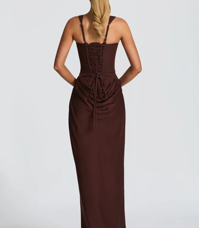 Side angle of chocolate brown square neck corset maxi dress with fitted silhouette and draped skirt