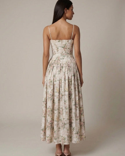 Back view of cream floral corset midi dress with thin straps and gathered skirt silhouette
