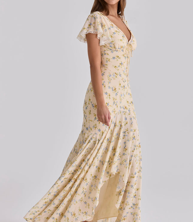 Cream floral lace v-neck maxi dress shown in side profile with flowing hem and front slit