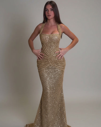 Gold sequin halter maxi dress with ruched waist and fitted mermaid skirt, front view