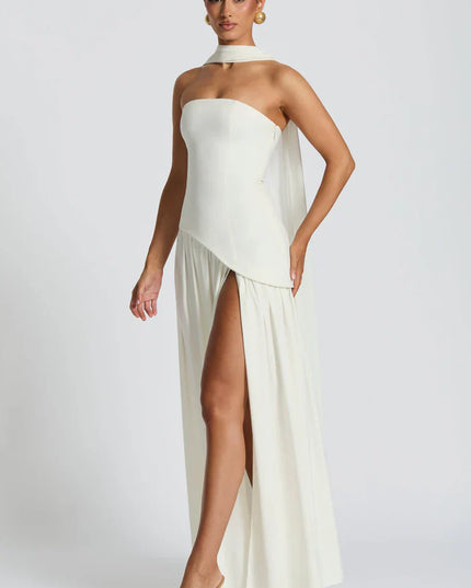Back view of ivory halter maxi dress with lace-up back, open shoulders, and long scarf