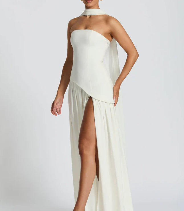 Back view of ivory halter maxi dress with lace-up back, open shoulders, and long scarf