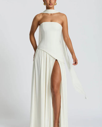 Front view of ivory halter maxi dress with asymmetrical overlay and flowing skirt
