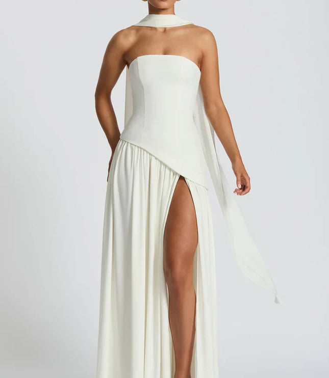 Front view of ivory halter maxi dress with asymmetrical overlay and flowing skirt
