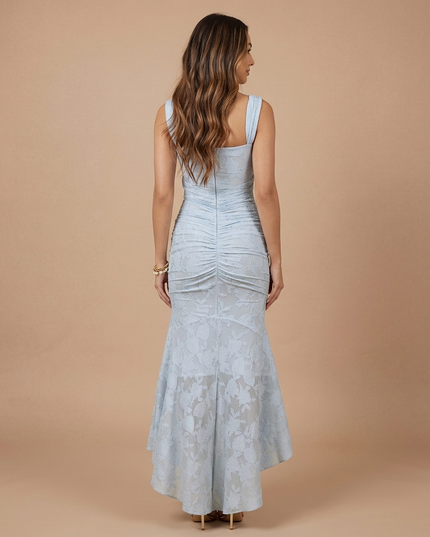 Light blue lace midi dress back view with wide straps, center seam ruching and flared high-low skirt