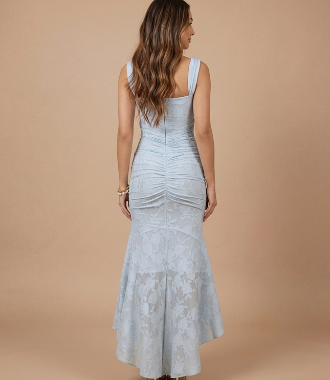 Light blue lace midi dress back view with wide straps, center seam ruching and flared high-low skirt