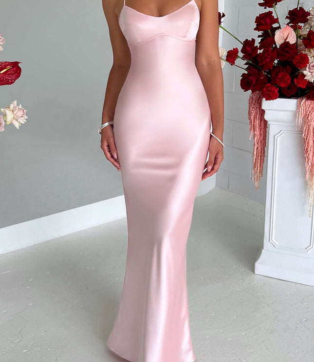 Full front view of the elegant pink satin maxi dress, highlighting its flowing silhouette and delicate straps.