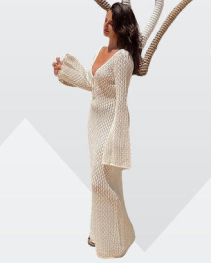 Side profile of a white long sleeve crochet maxi dress with a deep V-neck, showcasing the full length and bell sleeves.