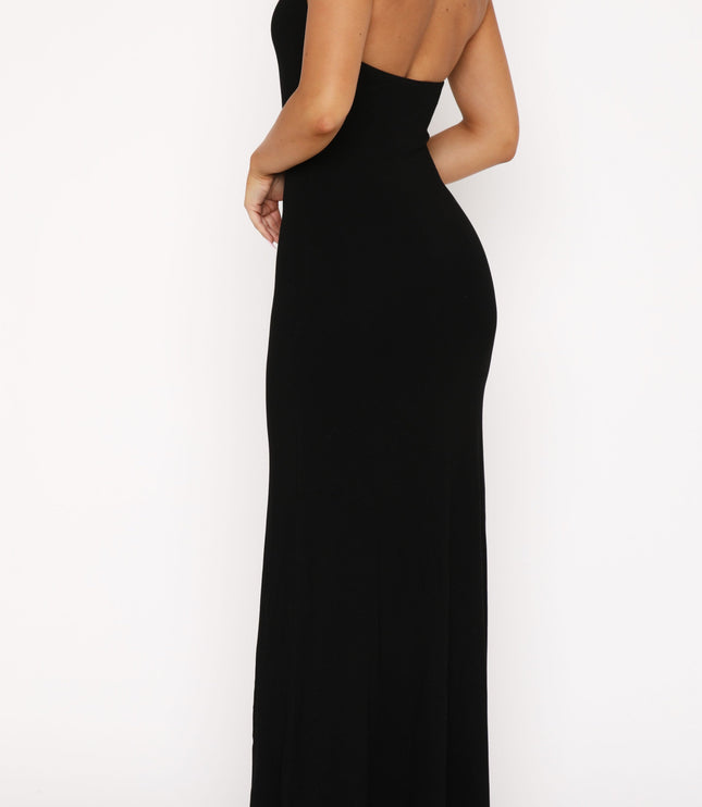 Back view of the black halter scoop neck maxi dress, featuring the open back design and long skirt.