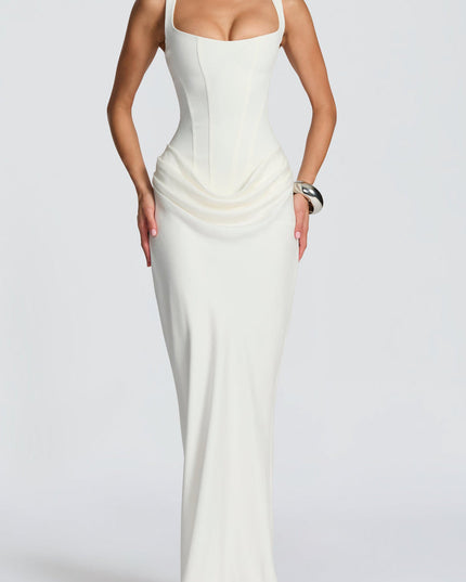 Full length view of a sophisticated white women's maxi dress with a square neckline, structured corset, and soft draping.