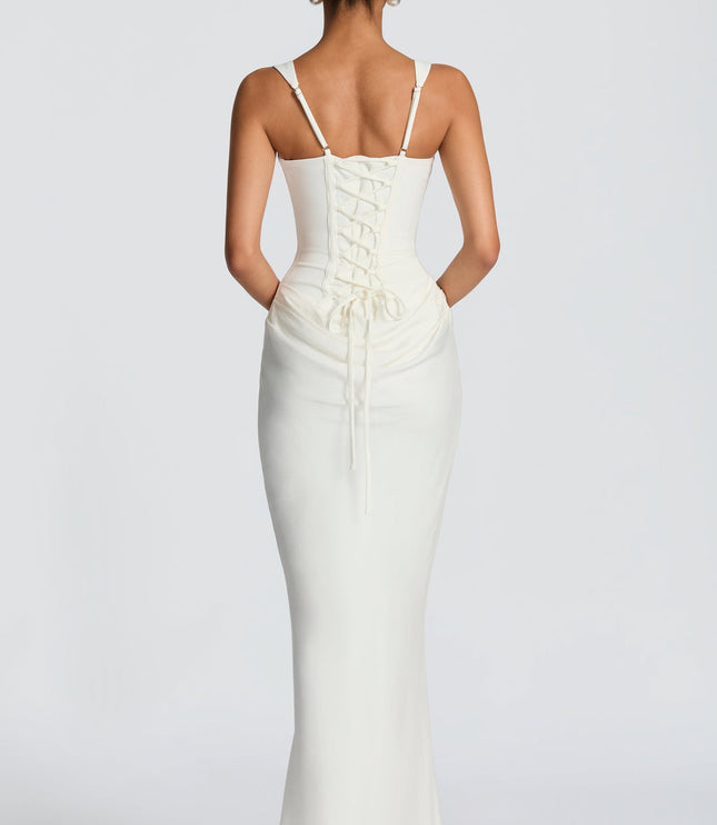 Back view of the white square neck corset maxi dress, showcasing the lace-up corset detail on the back.