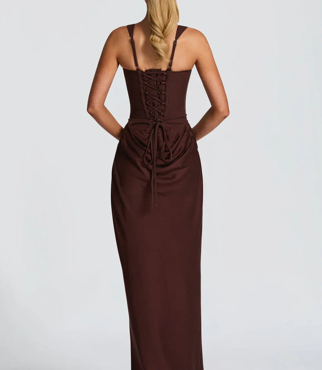 Back view of a women's black square neck draped corset maxi dress, featuring a lace-up back detail.