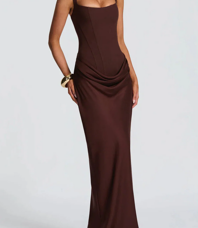 Full-length front view of a women's black square neck draped corset maxi dress, with a subtle side drape.