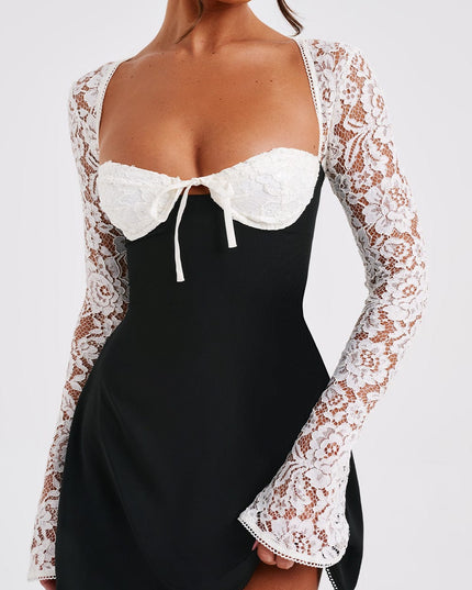 Close-up of the black and white lace long sleeve mini dress, focusing on the white lace bust and tie detail.