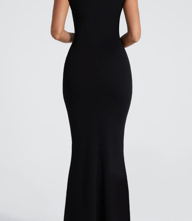 Back view of the black maxi dress, showcasing the smooth, form-fitting silhouette and subtle flare at the hem.