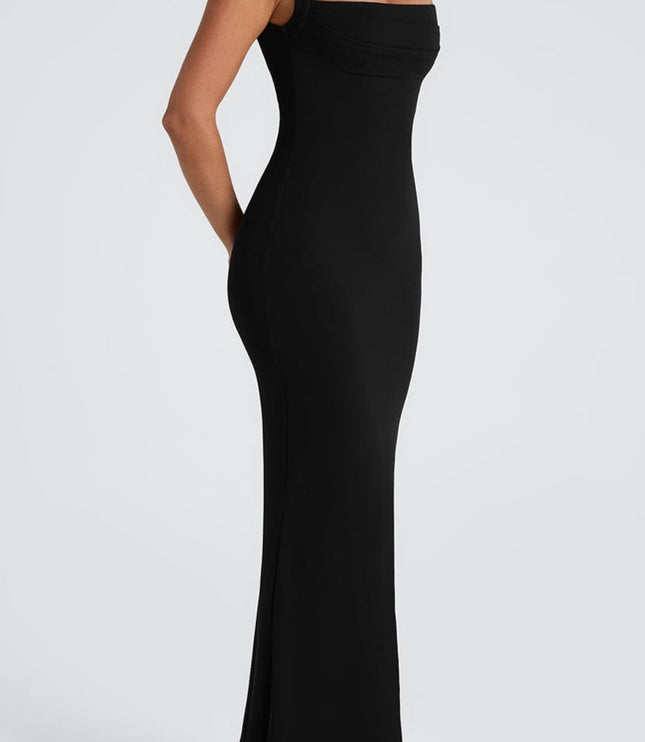 Side profile of the black maxi dress, emphasizing the elegant drape of the fabric and fit.