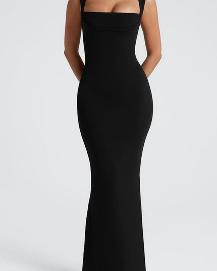 Full front view of the black square neck dress, ideal as a bridesmaid dress, with hands clasped behind the back.