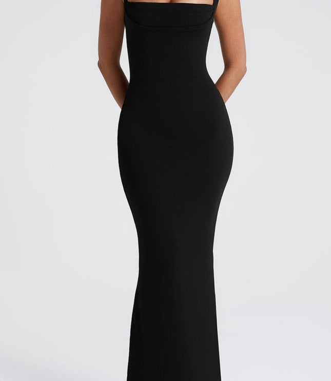 Full front view of the black square neck dress, ideal as a bridesmaid dress, with hands clasped behind the back.