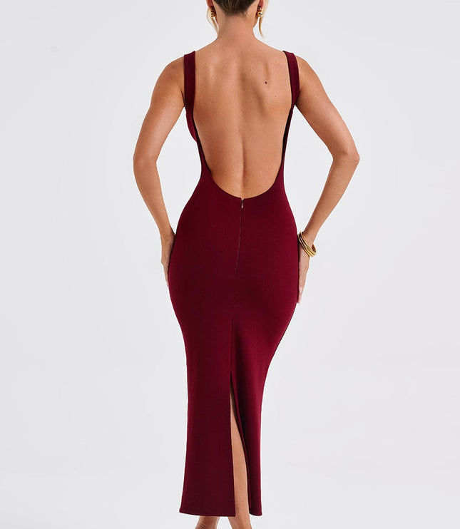 Back view of a women's burgundy midi dress showcasing the low back design and a discreet slit, worn with nude heels.
