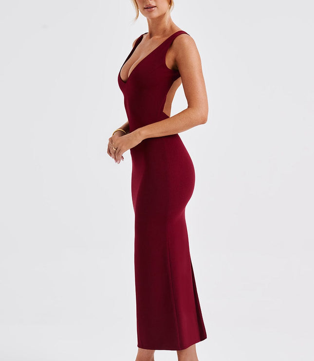 Side view of a women's burgundy midi dress, showing the deep V-neckline and low-cut back, with a side slit.