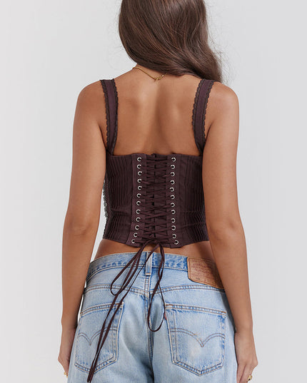 Back view of a dark brown bustier lace-up corset crop top, clearly displaying the intricate lacing from top to bottom with ties hanging down.