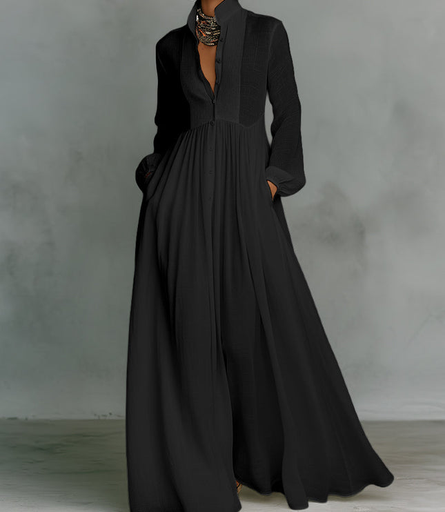 Black button-down stand collar jumpsuit with elegant lantern sleeves and flowing wide-leg pants, for evening wear.