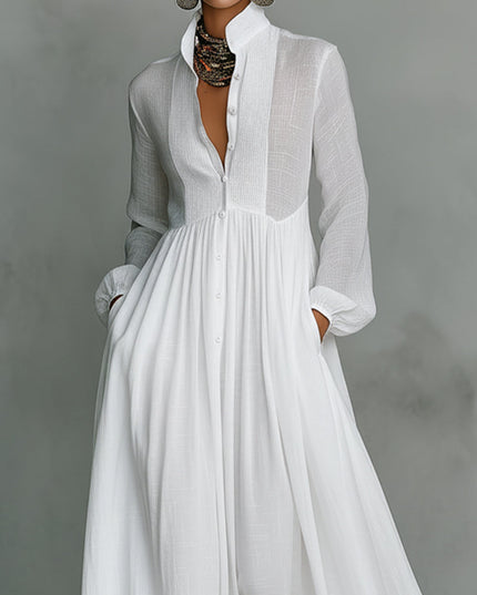 Close-up of the white stand collar jumpsuit, showing button-down front, pleated bodice detail, and lantern sleeves.